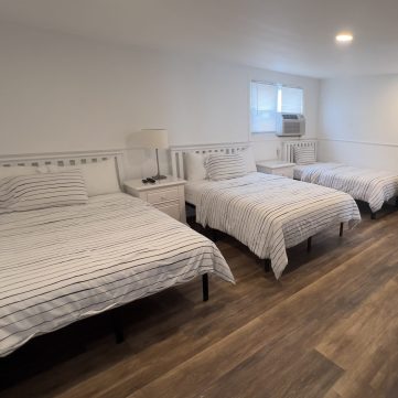 Triple bed suite with queen, full, and twin beds at Driftwood Motel in Point Pleasant Beach, NJ